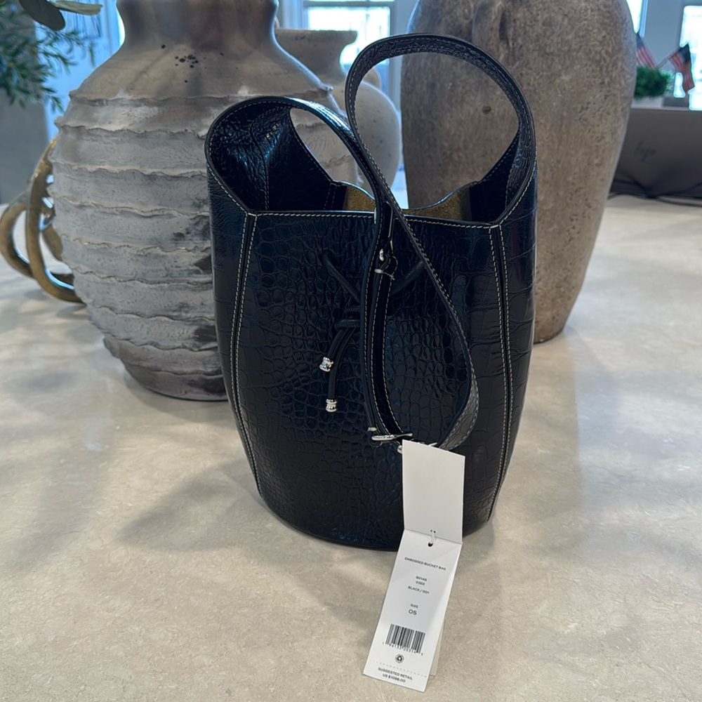 Tory Burch black leather embossed bucket bag with tan interior.Includes dust bag